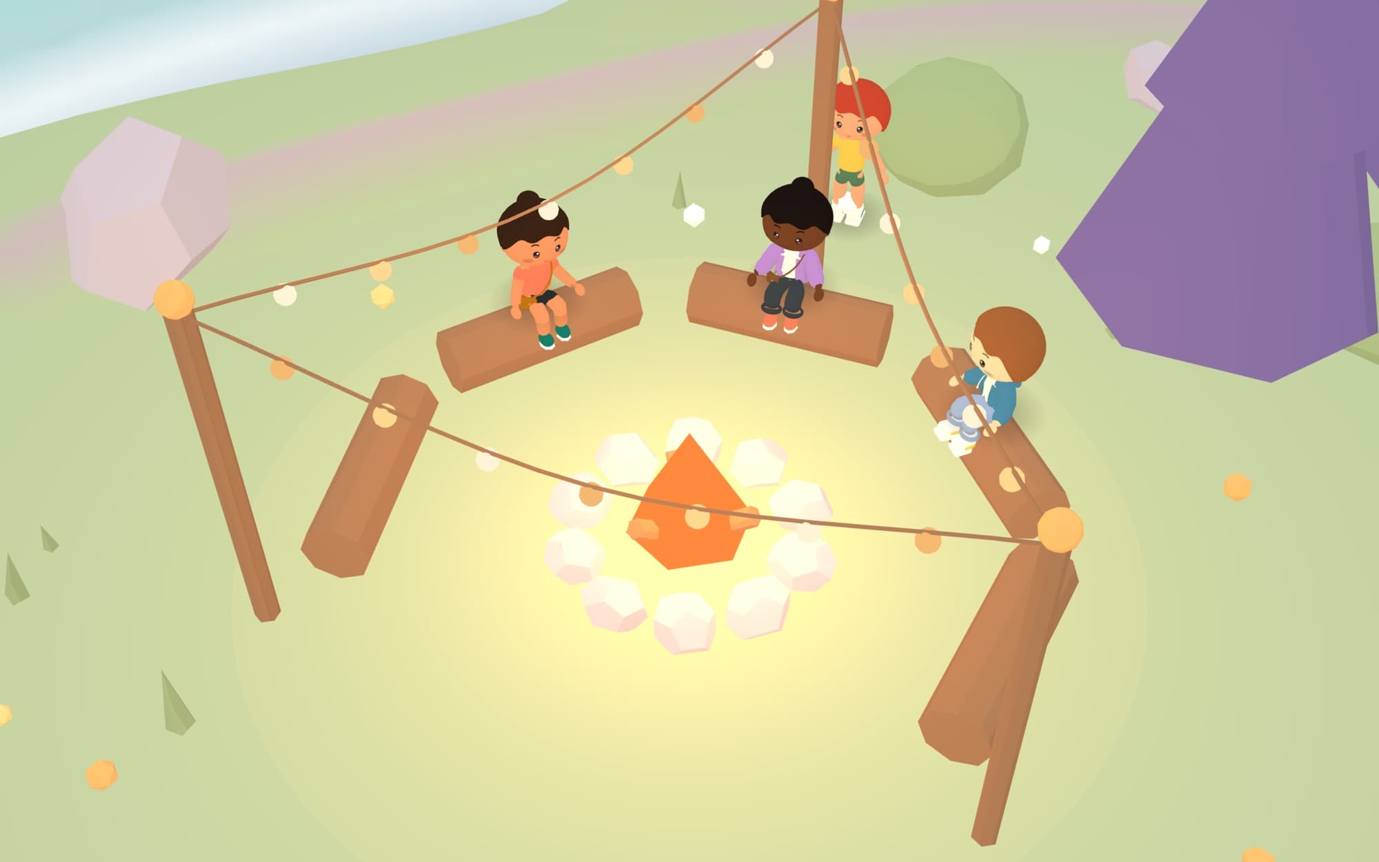 Four Islanders sitting together around a fire at dusk under string lights